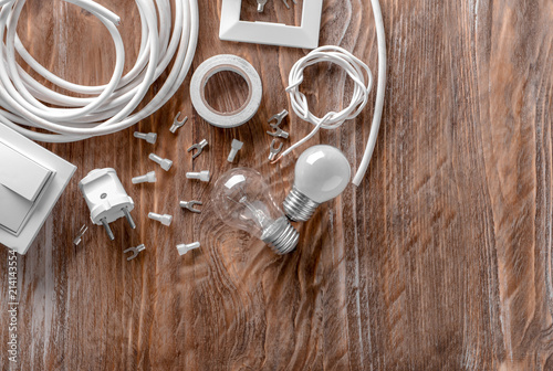 Electrician's supplies on wooden background