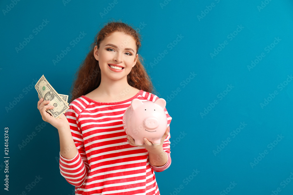 Young woman holding piggy bank and dollar banknotes on color background. Money savings concept Young woman holding piggy bank and dollar banknotes on color background. Money savings concept