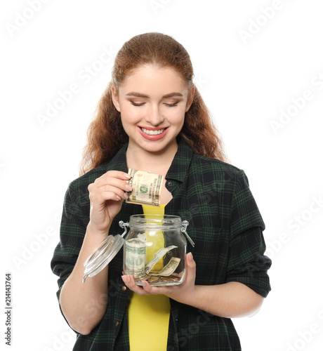 Young woman putting dollar ...