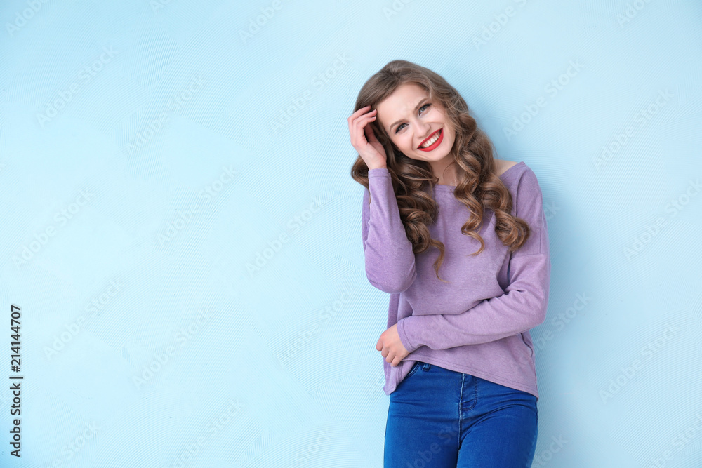 Beautiful young woman on color background