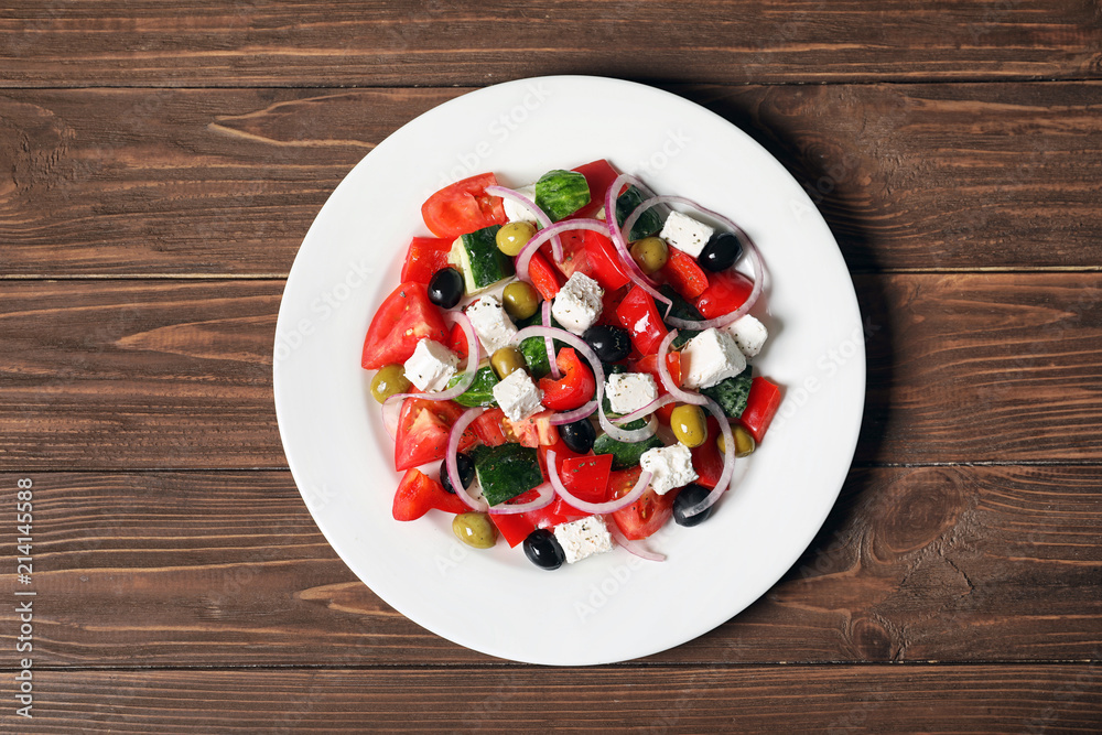 Plate with delicious salad on table, top view Plate with delicious salad on table, top view