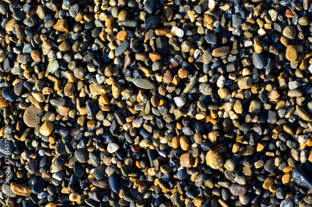 Multicolored small stones on the sea shore