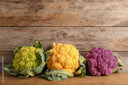 Colorful cauliflower cabbages on wooden table. Healthy food