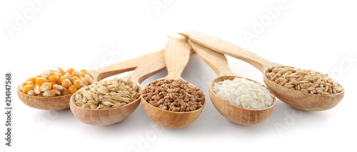 Spoons with different types of grains and cereals on white background