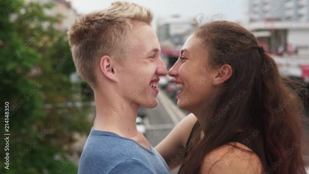 Happy loving teenager boy and girl look at each other and fun laughing in city Happy loving teenager boy and girl look at each other and fun laughing in city