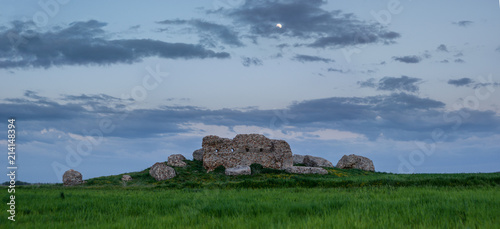 Full moon over ancient ruins in a field photo