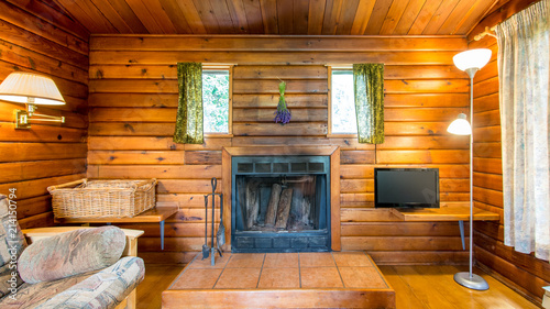 Foto Cozy interior of a living room in a rustic log cabin.