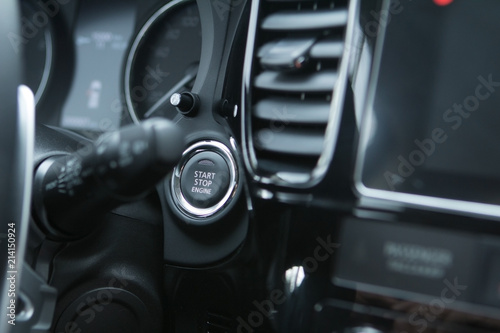 Car engine start stop button of a modern car. © Designer