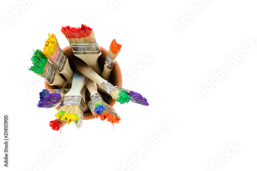 Paint brushes with colorful paint on the bristles