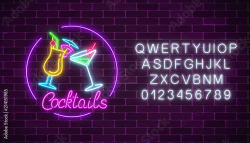 Neon cocktails bar sign with alphabet and two glasses of cocktails. Glowing gas advertising with glasses of alcohol.