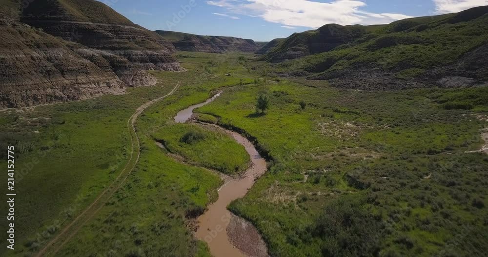 4K Green Valley and stream in Drumheller, Alberta, Canada - daytime, Aerial, low elevation, revealing shot 4K Green Valley and stream in Drumheller, Alberta, Canada - daytime, Aerial, low elevation, revealing shot