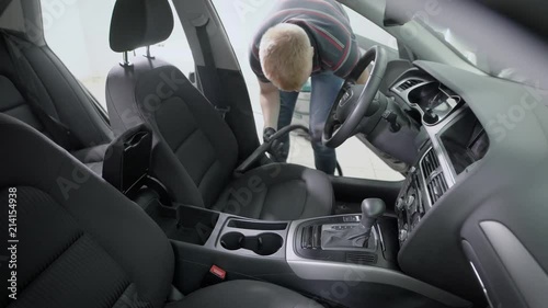Wallpaper Mural Man vacuuming car interior Torontodigital.ca