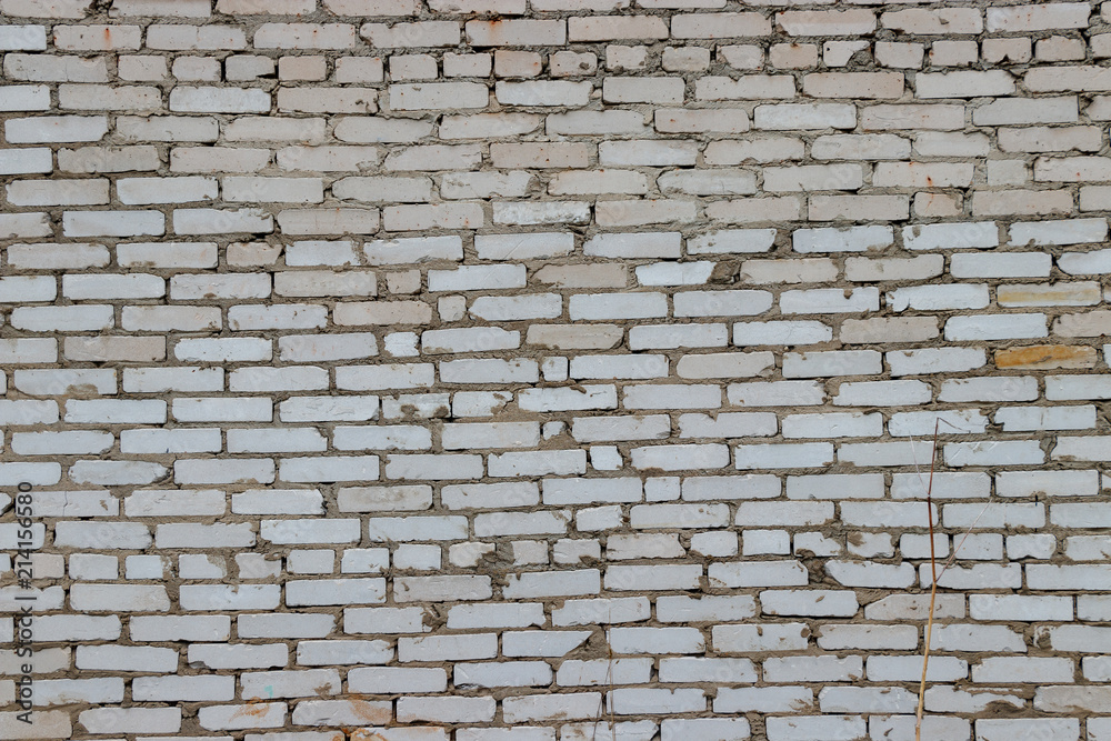 Background of sloppy folded white brick wall. Between the bricks a lot of extra cement Background of sloppy folded white brick wall. Between the bricks a lot of extra cement