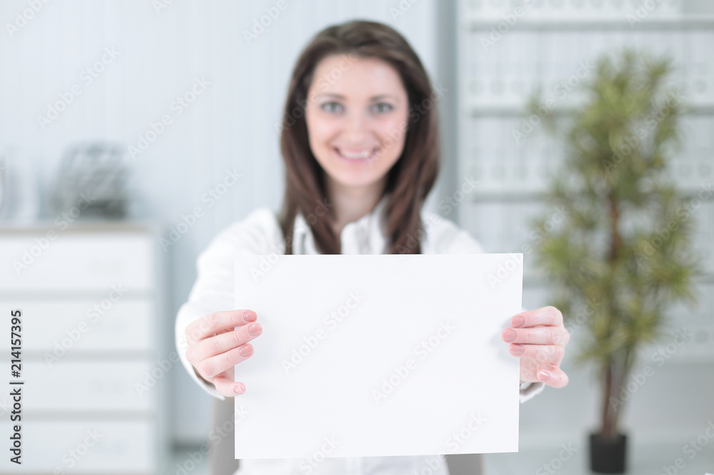 business woman showing blank sheet,sitting behind a Desk business woman showing blank sheet,sitting behind a Desk