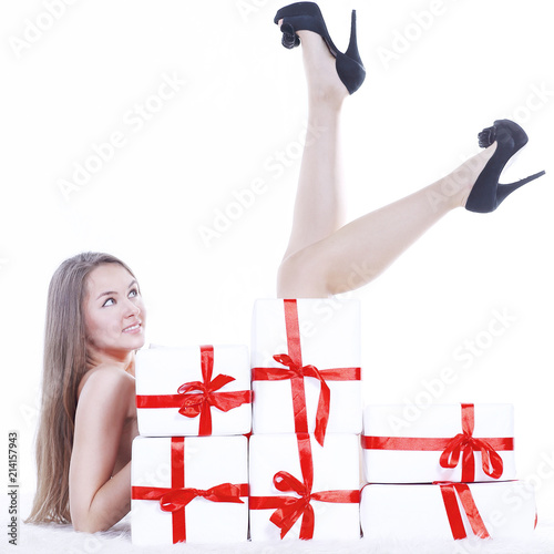beautiful young woman in Christmas costume lying near the pile 