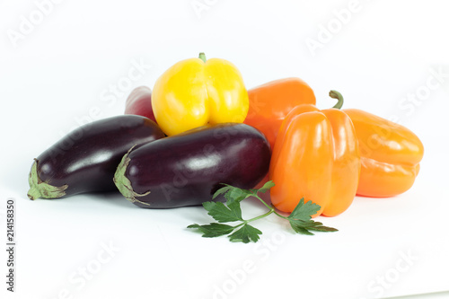 bell pepper,eggplants and sprigs of parsley on a white backgroun