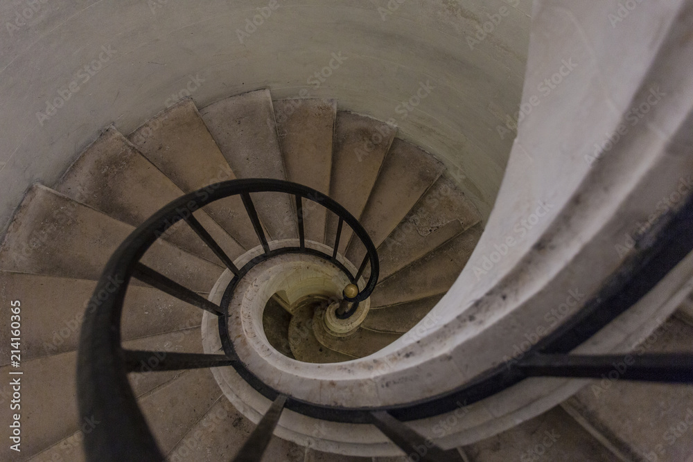 Fototapeta premium Spiral stairway leading down in a classic building