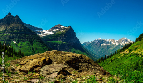 Mount Oberlin on the left and with Cannon Mountain center and Clements Mountain to the right stand tall against a clear blue sky in GNP. photo