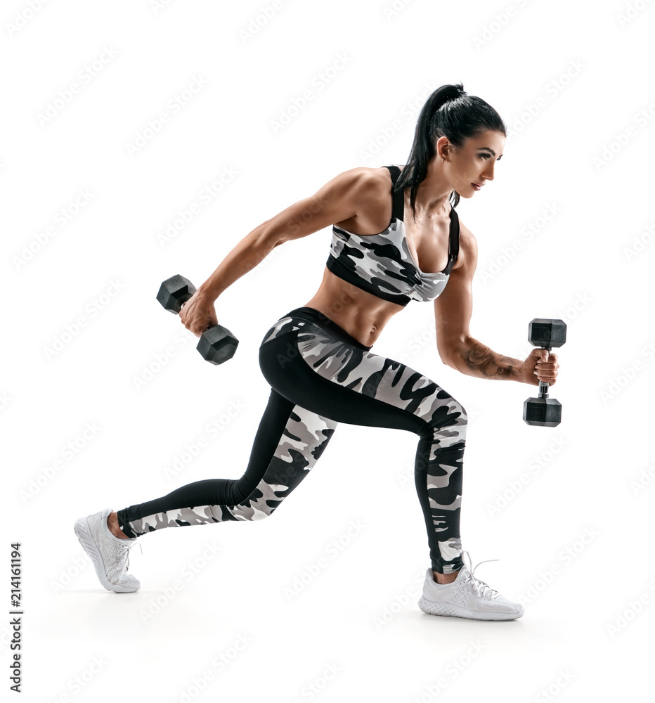 Sporty woman training muscles of hands and legs using a dumbbells. Photo of muscular latin woman in military sportswear isolated on white background. Strength and motivation. Side view Sporty woman training muscles of hands and legs using a dumbbells. Photo of muscular latin woman in military sportswear isolated on white background. Strength and motivation. Side view
