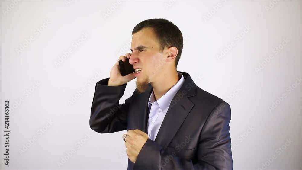 young bearded man talking on the phone. bad news. young bearded man talking on the phone. bad news.