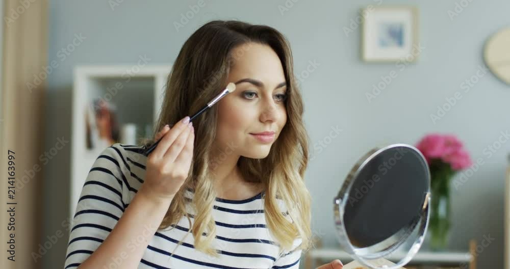 Young pretty beauty blogger woman teaching how to do make upp for eyes in her tutorial video. Inside. Young pretty beauty blogger woman teaching how to do make upp for eyes in her tutorial video. Inside.