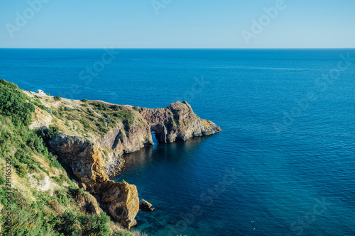 Rock with arched grotto at Black sea, aerial view