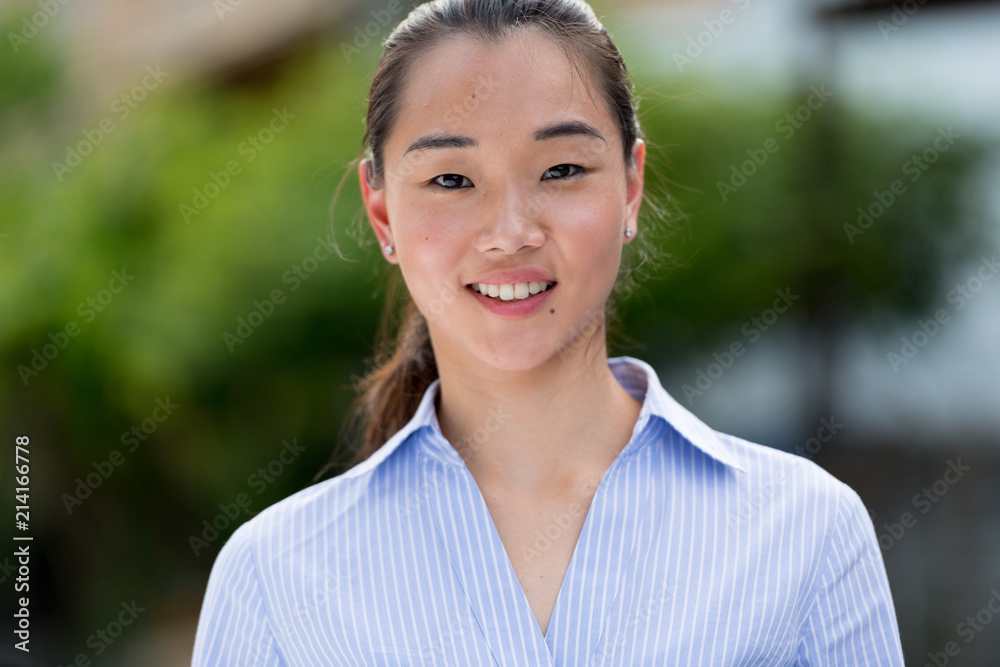 Young beautiful Asian businesswoman outdoors Young beautiful Asian businesswoman outdoors