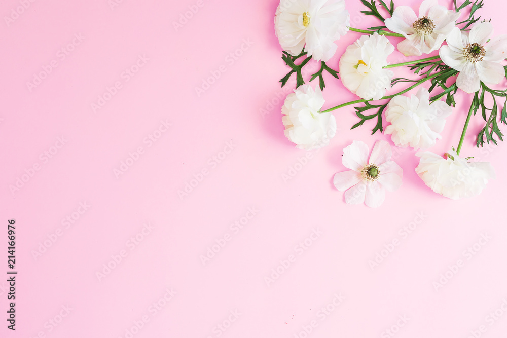 White flowers and petals on pink pastel background. Flat lay, top view. Floral pattern