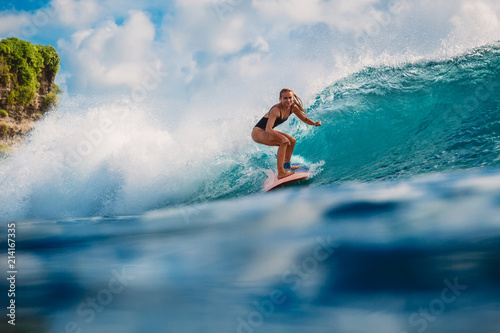 Surfer girl on wave in ocean © artifirsov