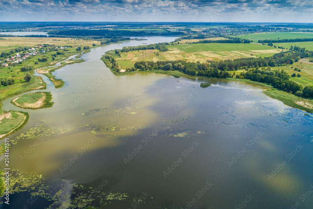 Aerial view of countryside and river. Blue sky with beautiful clouds
