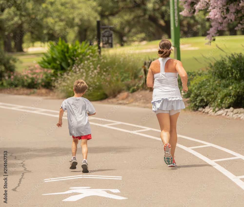 unknown mother and son are staying fit and running together