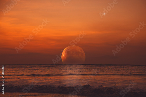 Rising Moon eclipse from the ocean horizon.