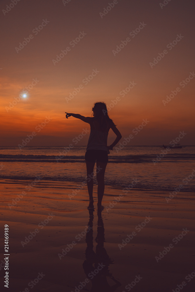 Girl looking at the star on the ocean / sea beach.