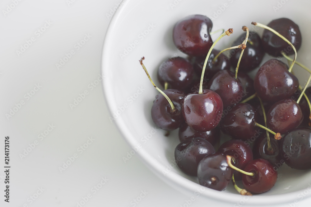 Plate with fresh cherry berries on white background. Bowl with cherries Plate with fresh cherry berries on white background. Bowl with cherries