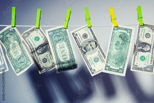 Dollar bills hanging and drying on clothesline. The concept of money laundering