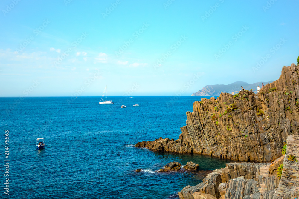 The rocky granite coastline at the Cinque Terre village of Riomaggiore, Italy