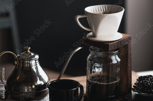 coffee In a glass bottle,Coffee drip,Hand holding a kettle Drip Coffee In the room