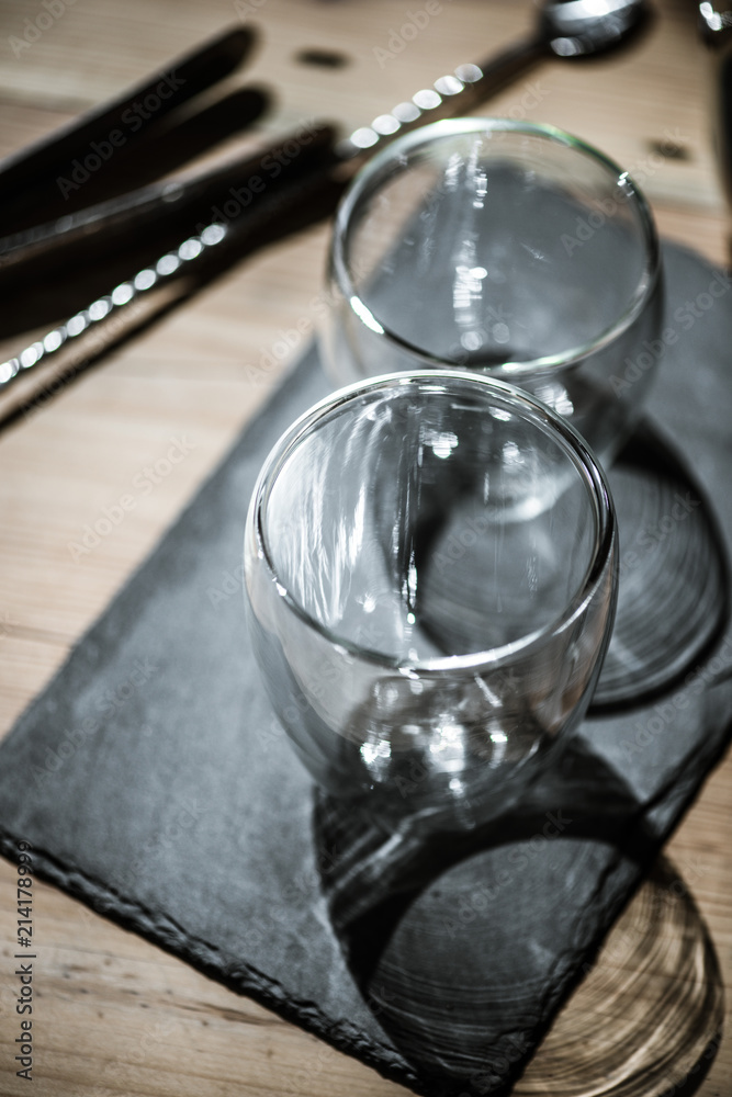 close-up view of fresh limes and empty glasses with shaker, selective focus