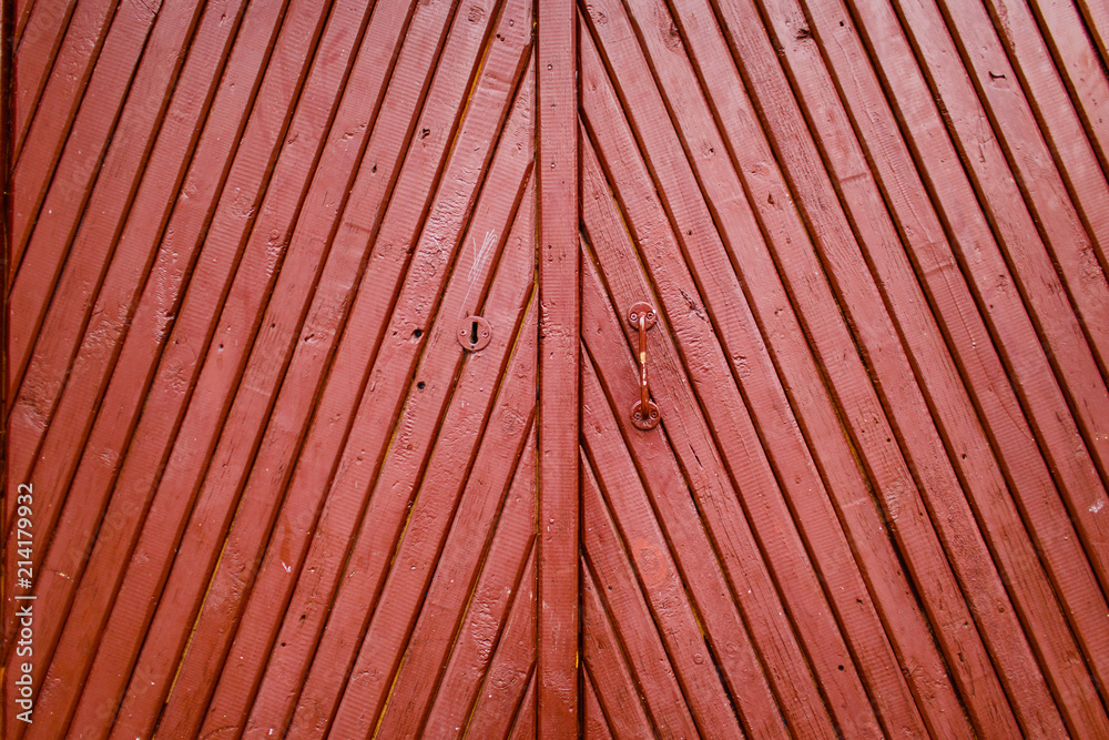 Old burgundy wooden door with handle and keyhole texture close-up Old burgundy wooden door with handle and keyhole texture close-up