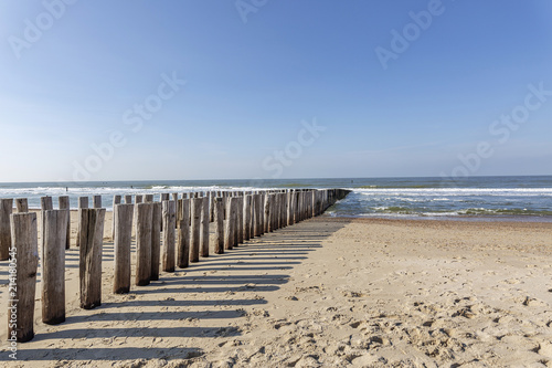 The Timber Piles throw their shadow on the Beach at Domburg/ Netherlands
