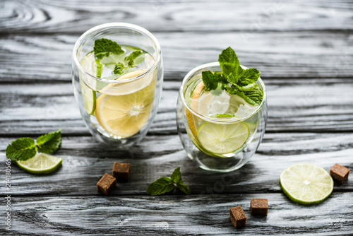close-up view of fresh cold mojito cocktail in glasses on wooden table