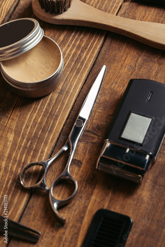 high angle view of professional barber tools on wooden surface in barbershop
