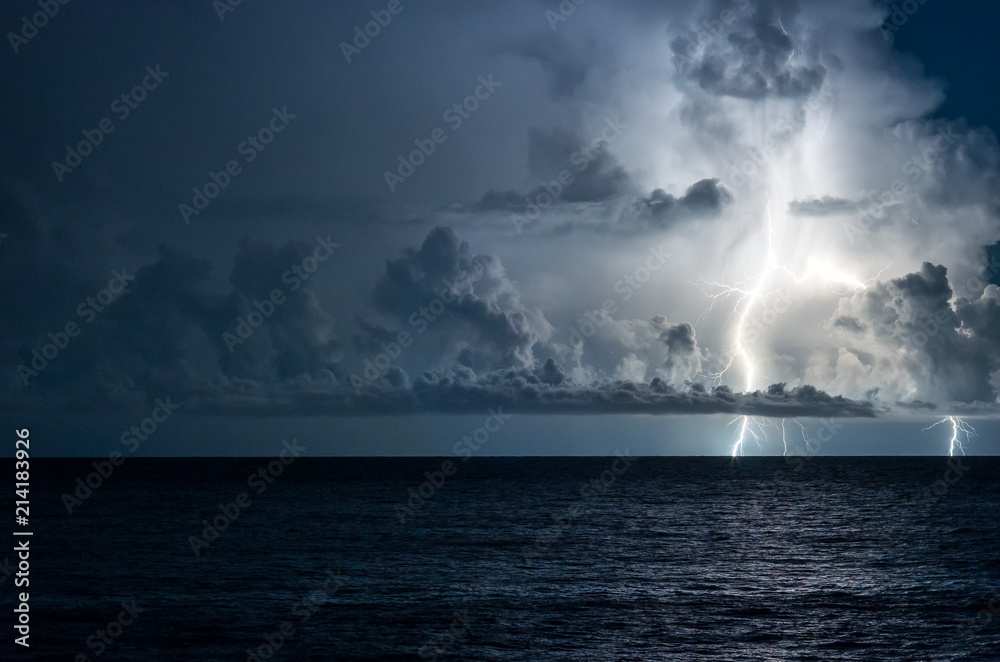 Lightning in the sea with high clouds