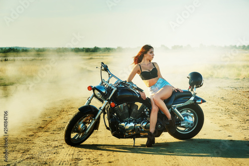Fototapeta Naklejka Na Ścianę i Meble -  Young woman resting sitting on a motorcycle . Travel and tourism concept
