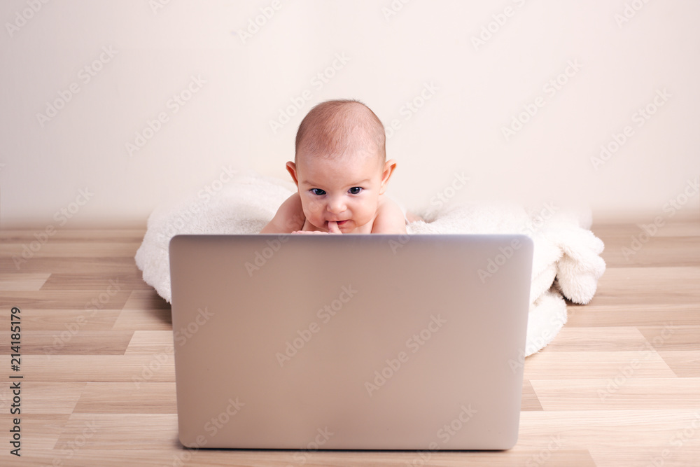 Small baby infant working playing learning on the laptop wireless serious face Small baby infant working playing learning on the laptop wireless serious face