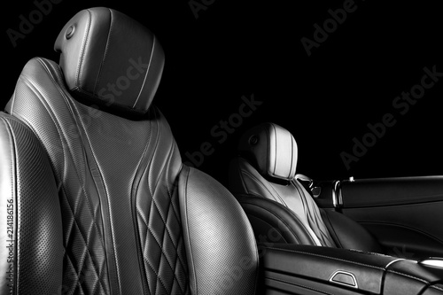 Modern Luxury car inside. Interior of prestige modern car. Comfortable leather seats. Perforated leather with isolated Black background. Modern car interior. Car detailing. Black and white