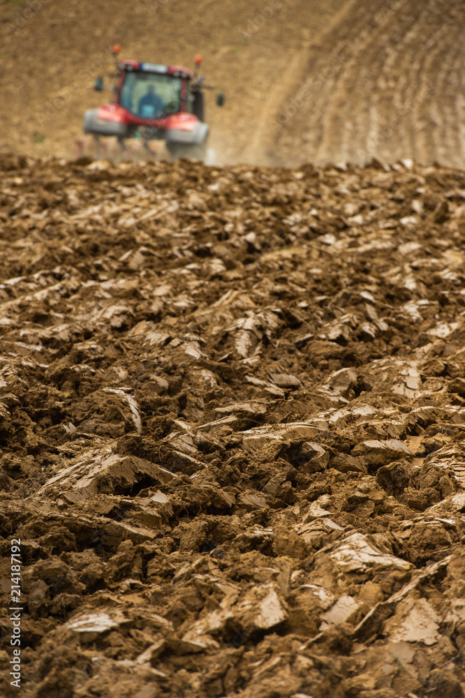 Farmer on tractor plow field, France Farmer on tractor plow field, France