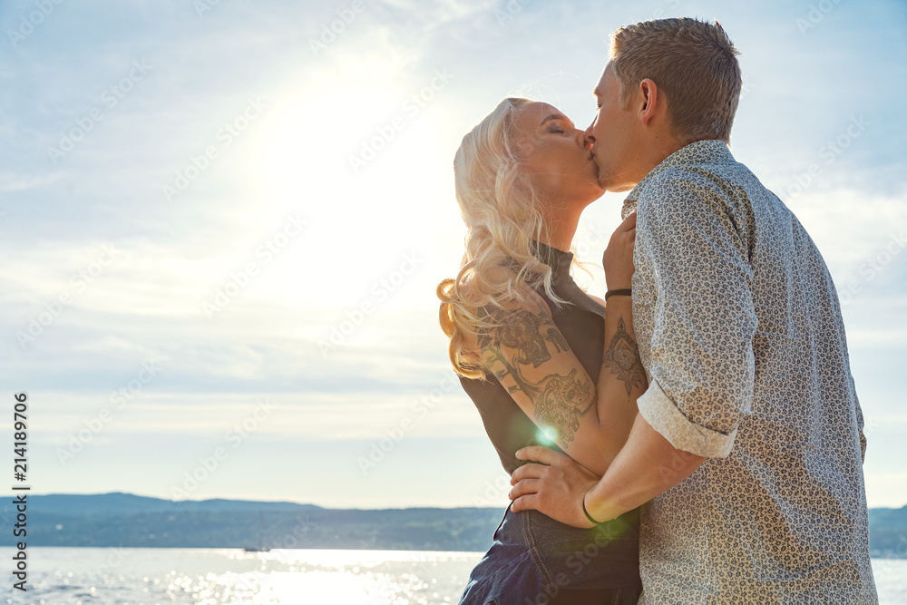 Romantic couple kissing and embrace on beach a sunny day Romantic couple kissing and embrace on beach a sunny day