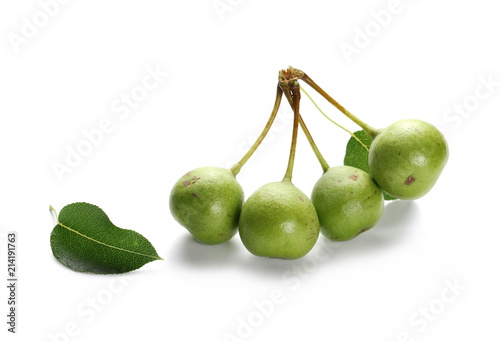 Wild, young green pears with twig and leaves isolated on white background