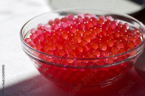 glass bowl full of red jelly balls photo
